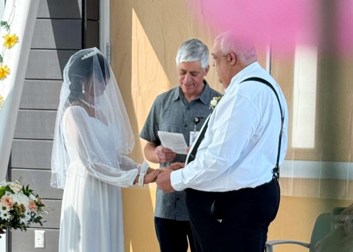 Alicia and Richard stand during their wedding ceremony in Wing B4 Bridge at CMH
