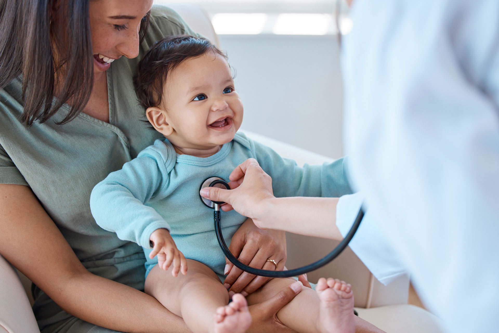 baby-sitting-on-her-mother's-lap-while-being-examined