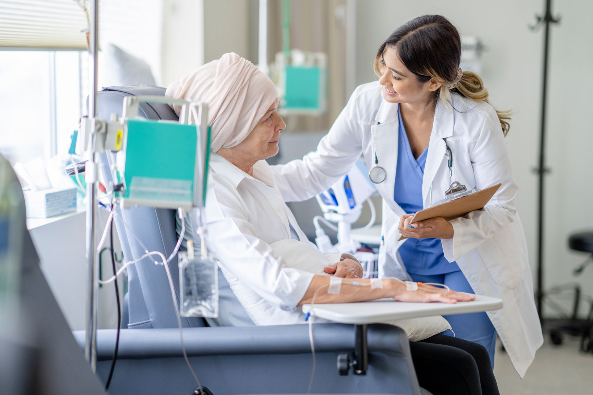 female doctor checking in on senior patient with cancer