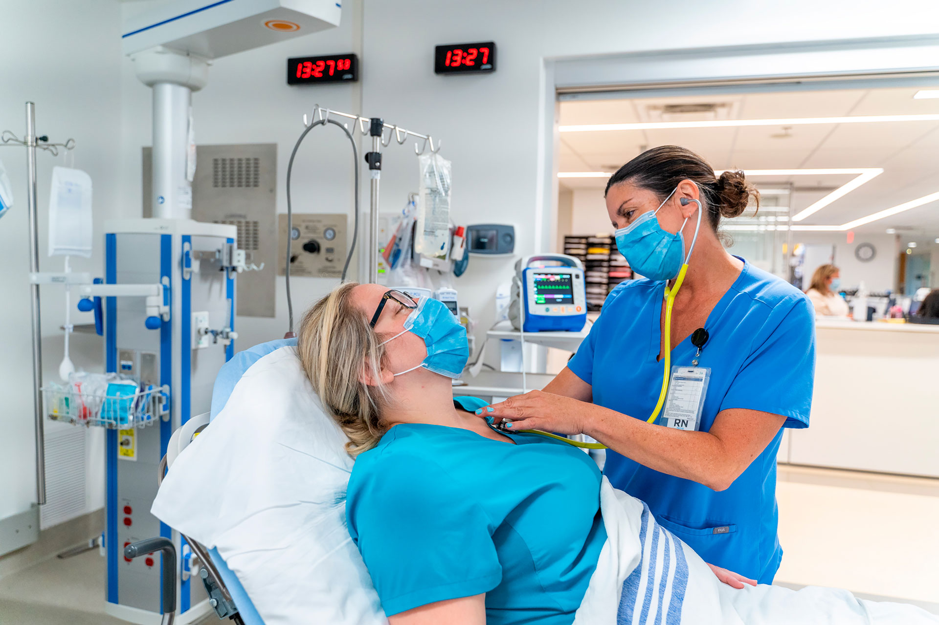 Nurse checking vitals with stethoscope 