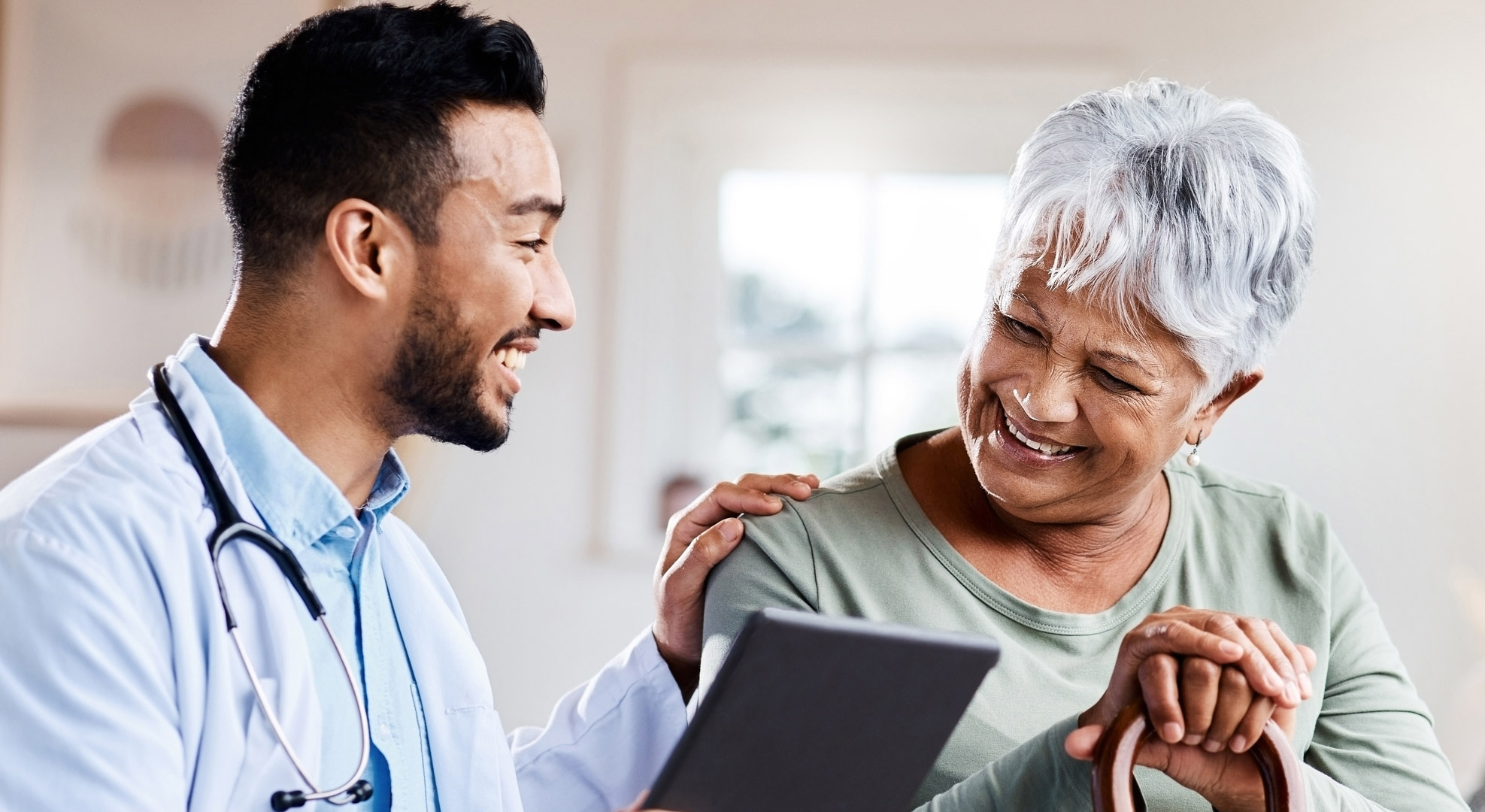 doctor-sharing-information-from-his-digital-tablet-with-an-older-patient