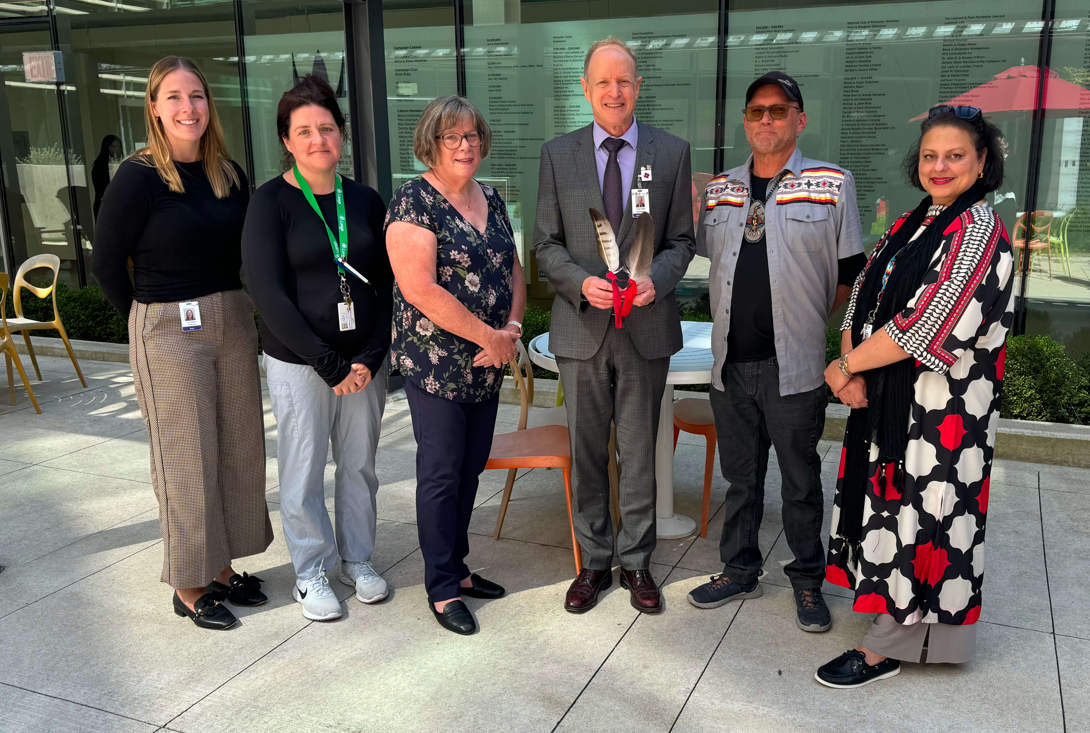 Some members of the Indigenous council, a board member and CEO stand with Clarence after the ceremony.