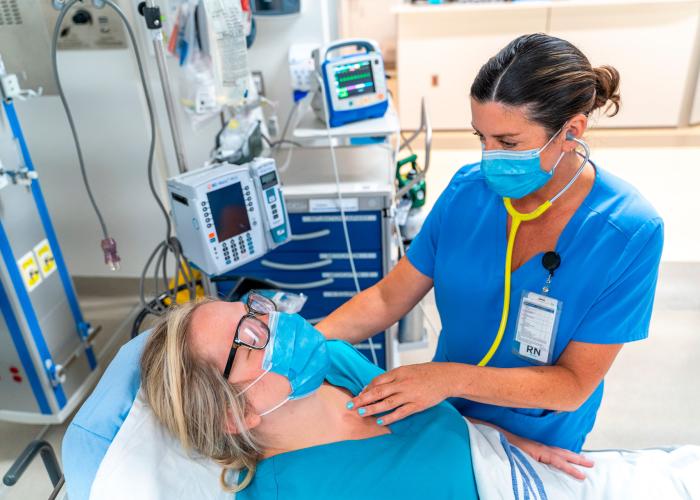Nurse checking vitals with stethoscope