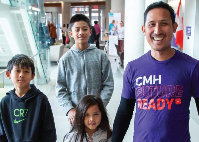 staff member father and children walking through cambridge memorial hospital