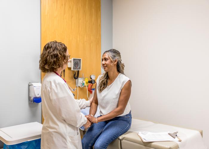 physician comforting a patient in exam room