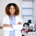 scientist standing with her arms folded